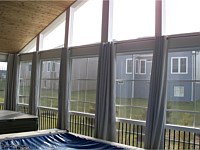 <b>A photo of the finished screened room from the interior, showing the Eze-Breeze sliding panel system that allows you to use your room all year round.</b>